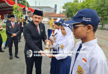 Marsono menyerahkan piala pada siswa berprestasi saat upacara peringatan Hari Pendidikan Nasional di halaman Kantor Bupati Tulungagung, Kamis (2/5)